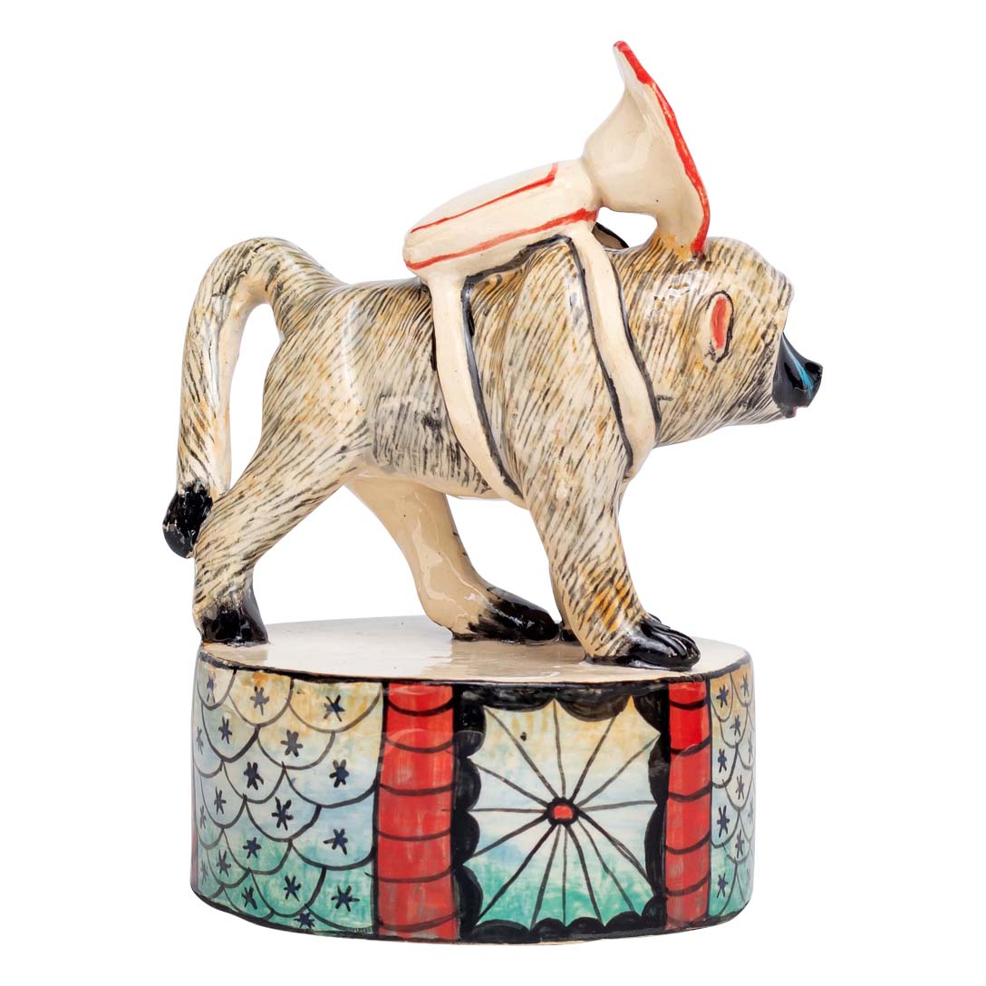 Baboon with trumpet sculpture