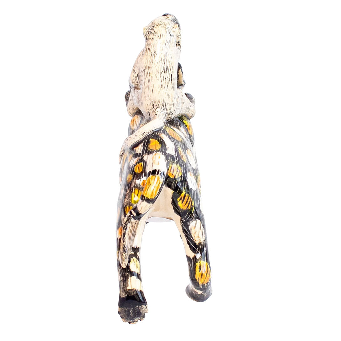 Wild dog monkey rider sculpture