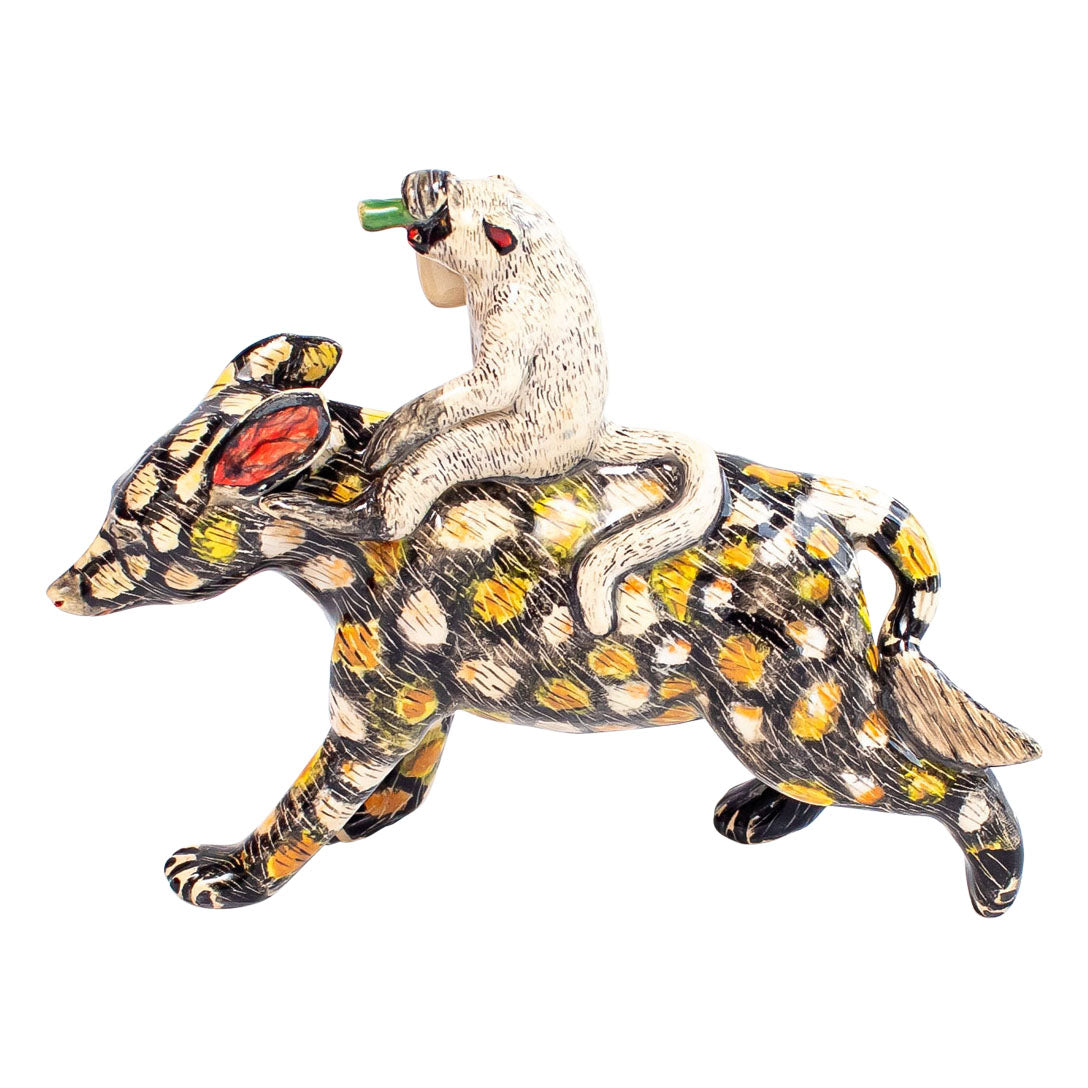 Wild dog monkey rider sculpture