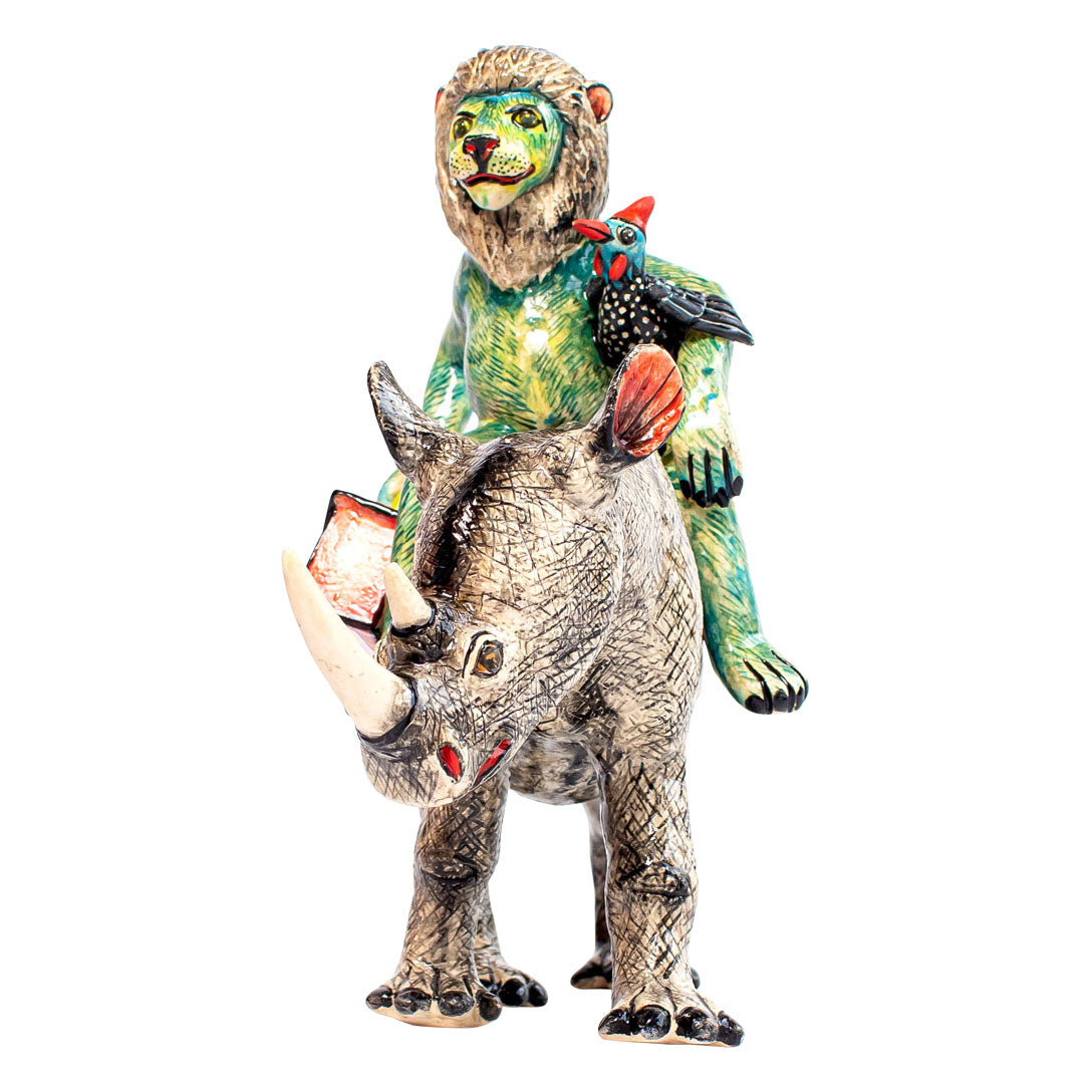 Blue rhino & lion rider sculpture