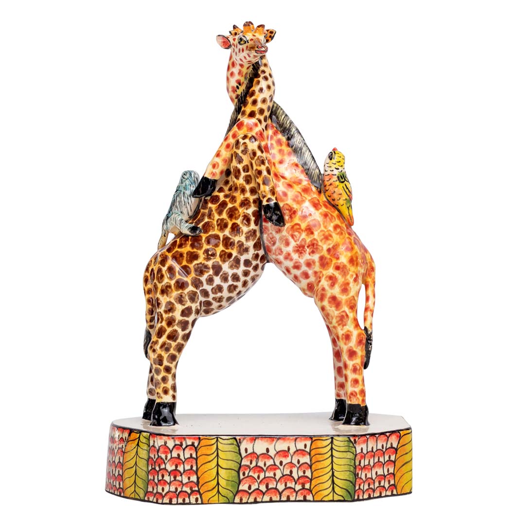 2 giraffes cuddling each other with 2 birds kissing each other sculpture