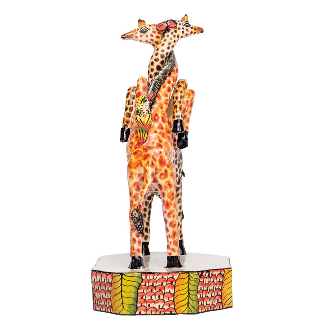 2 giraffes cuddling each other with 2 birds kissing each other sculpture