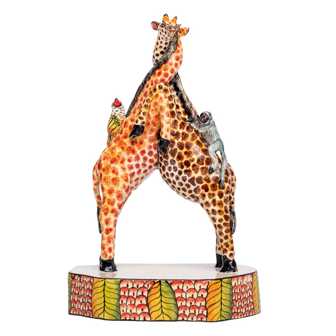 2 giraffes cuddling each other with 2 birds kissing each other sculpture