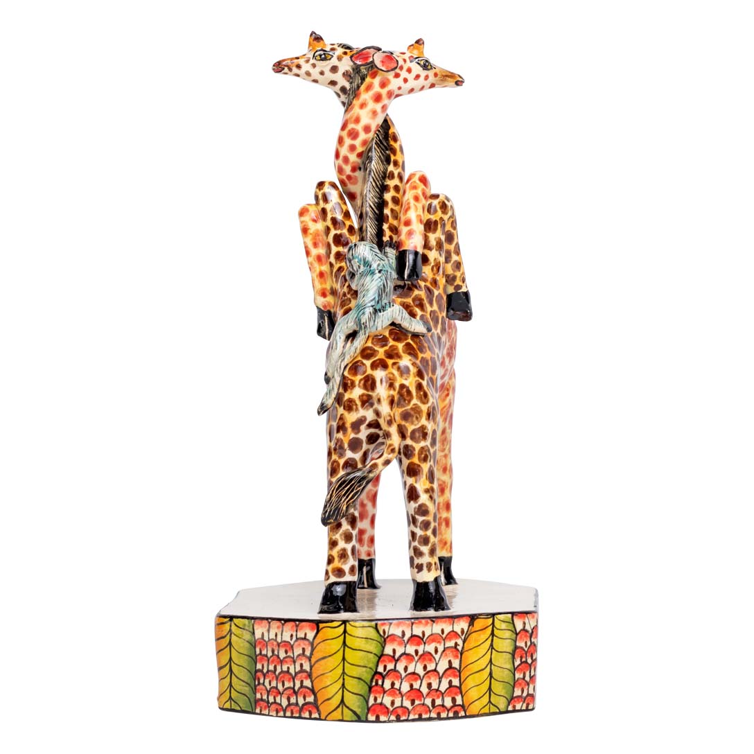 2 giraffes cuddling each other with 2 birds kissing each other sculpture