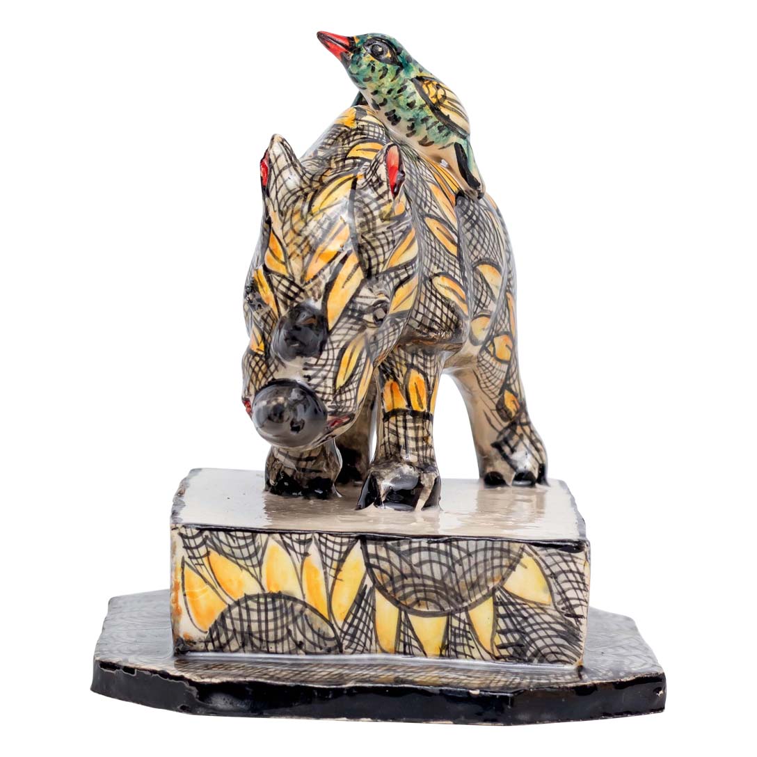 2 birds sitting on-top of a skin designed rhino sculpture