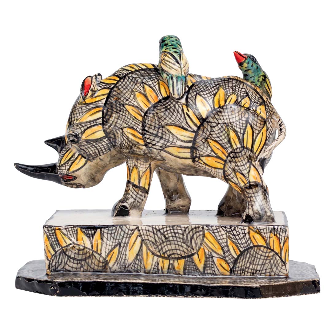 2 birds sitting on-top of a skin designed rhino sculpture