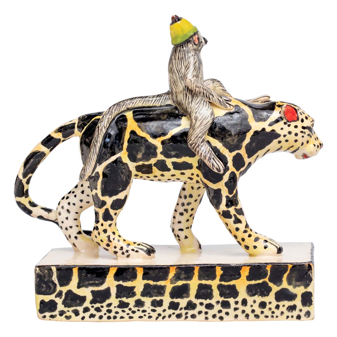 Monkey riding a black & yellow designed leopard sculpture