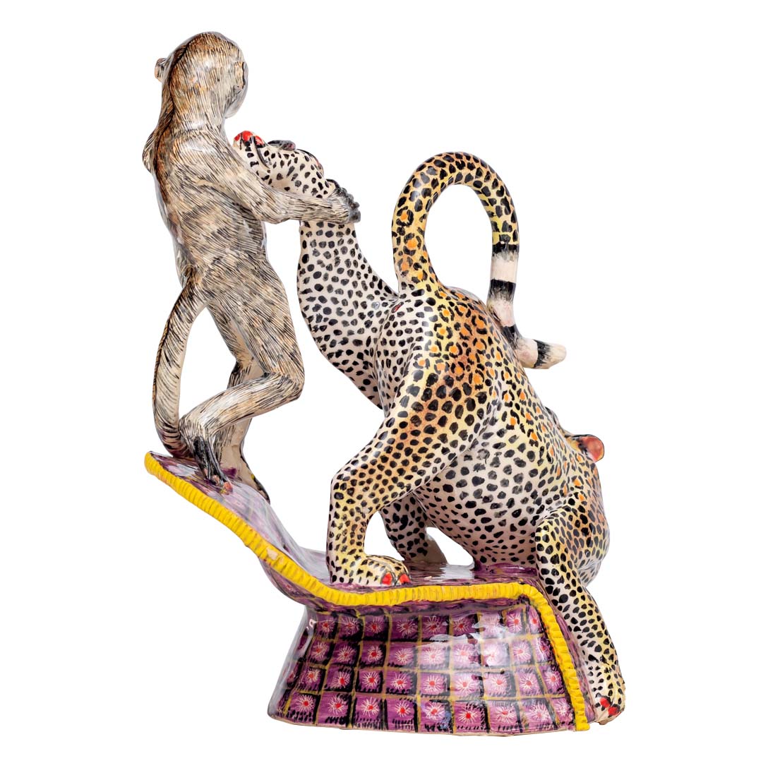 Monkey pulling the leopard's leg sculpture