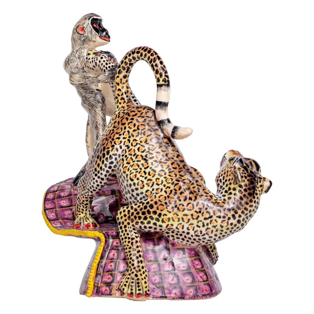 Monkey pulling the leopard's leg sculpture