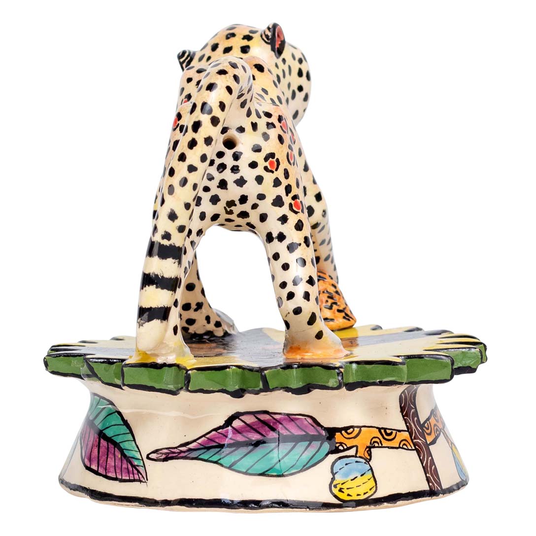 Leopard skin designed monkey puts 1 foot on the stone sculpture