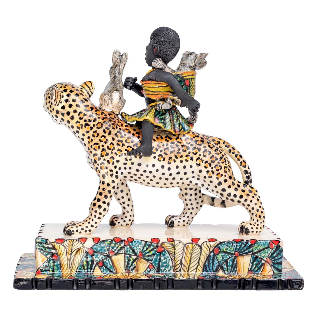 African women & 2 rabbits riding a leopard holding an umbrella sculpture