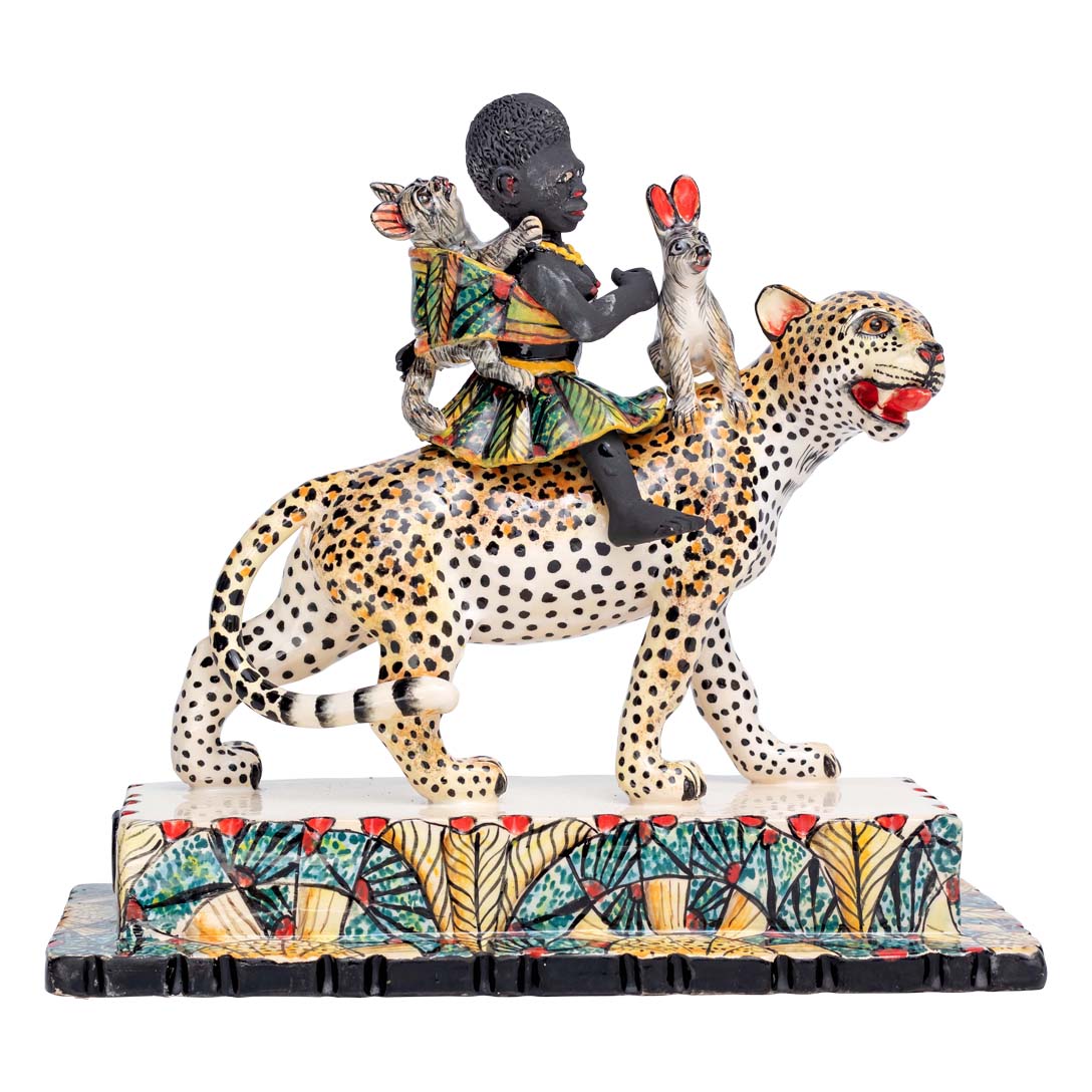 African women & 2 rabbits riding a leopard holding an umbrella sculpture