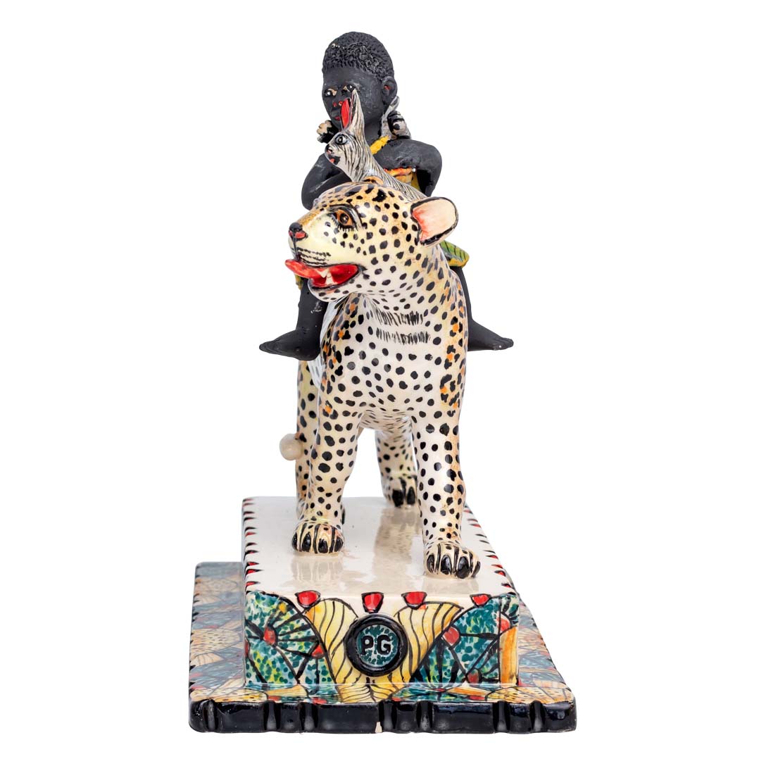 African women & 2 rabbits riding a leopard holding an umbrella sculpture