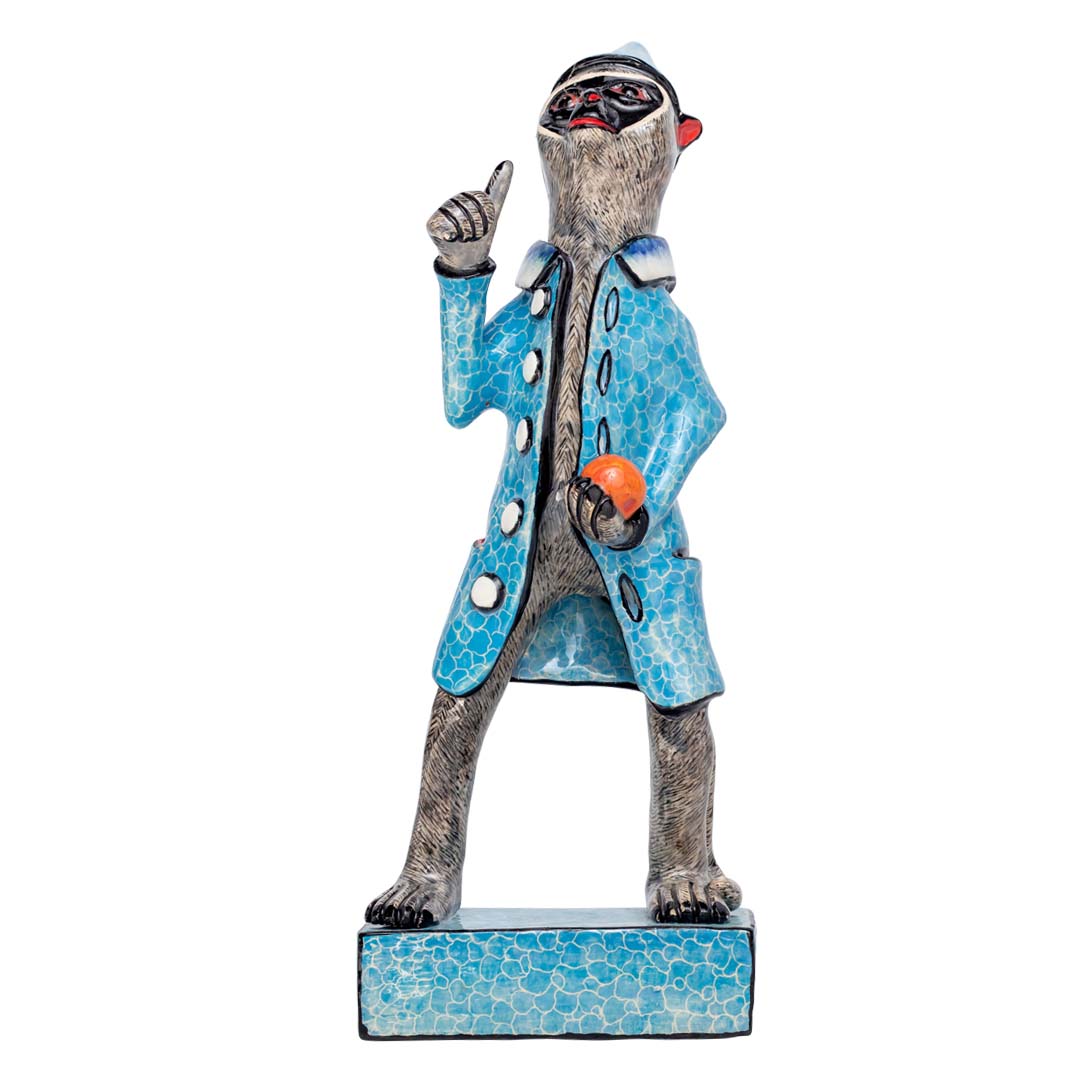 Monkey man wearing blue coat holding a ball sculpture