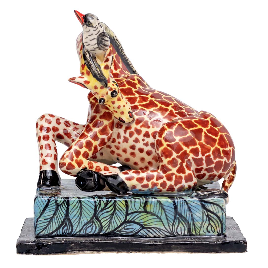 Giraffe playing with the bird sculpture