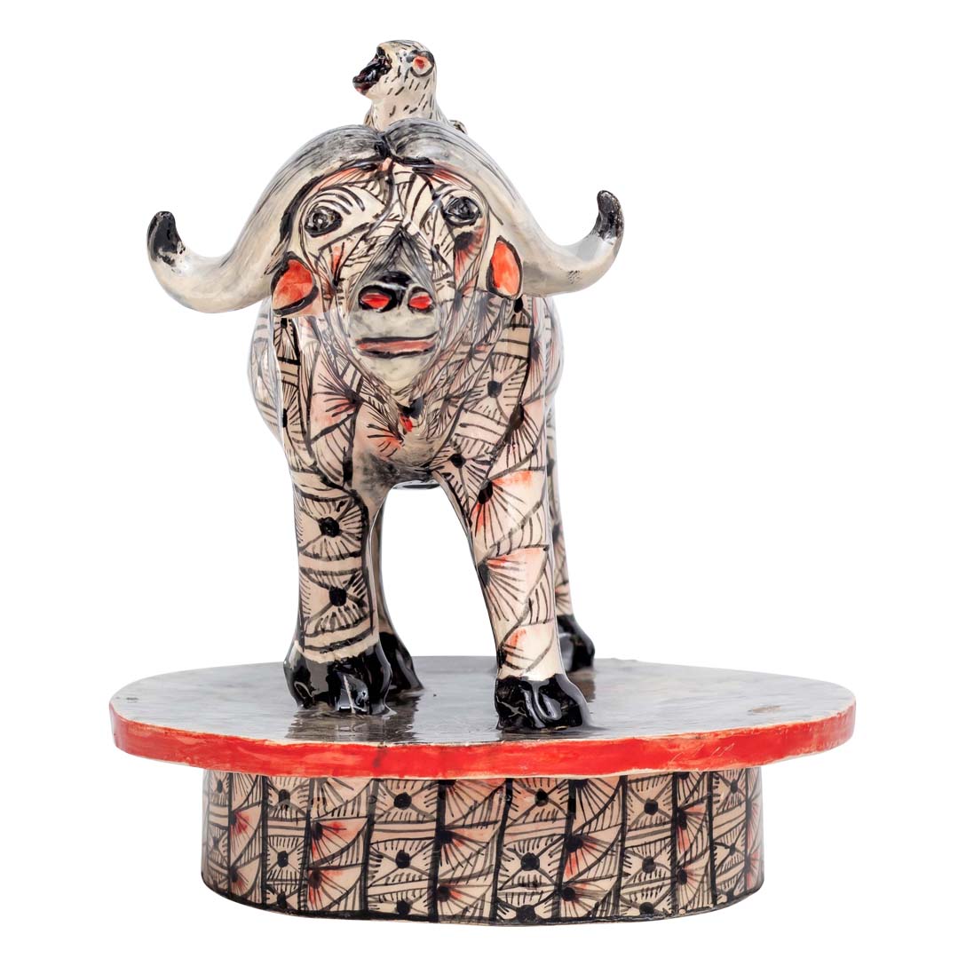 Monkey ridding a skin designed buffalo sculpture