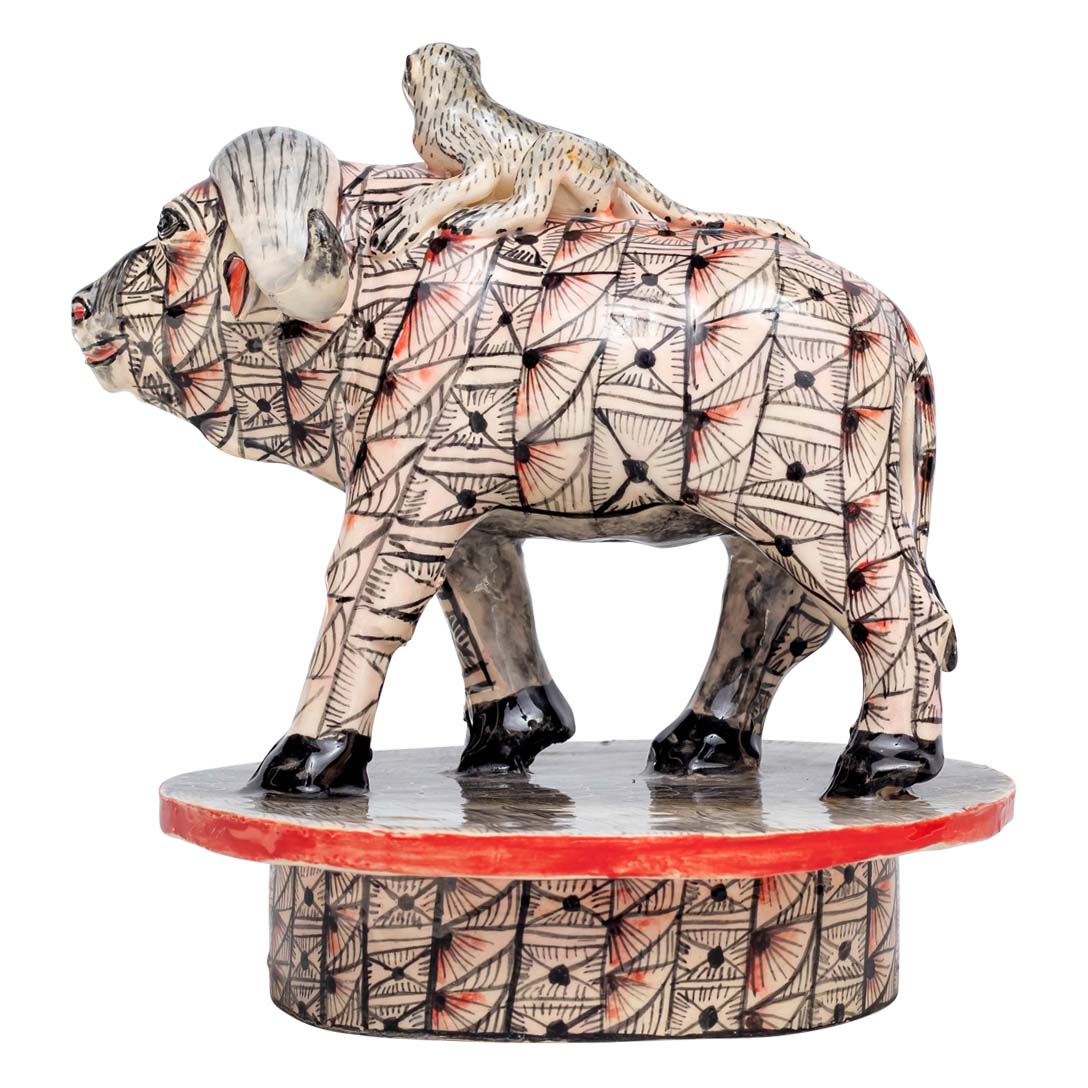 Monkey ridding a skin designed buffalo sculpture