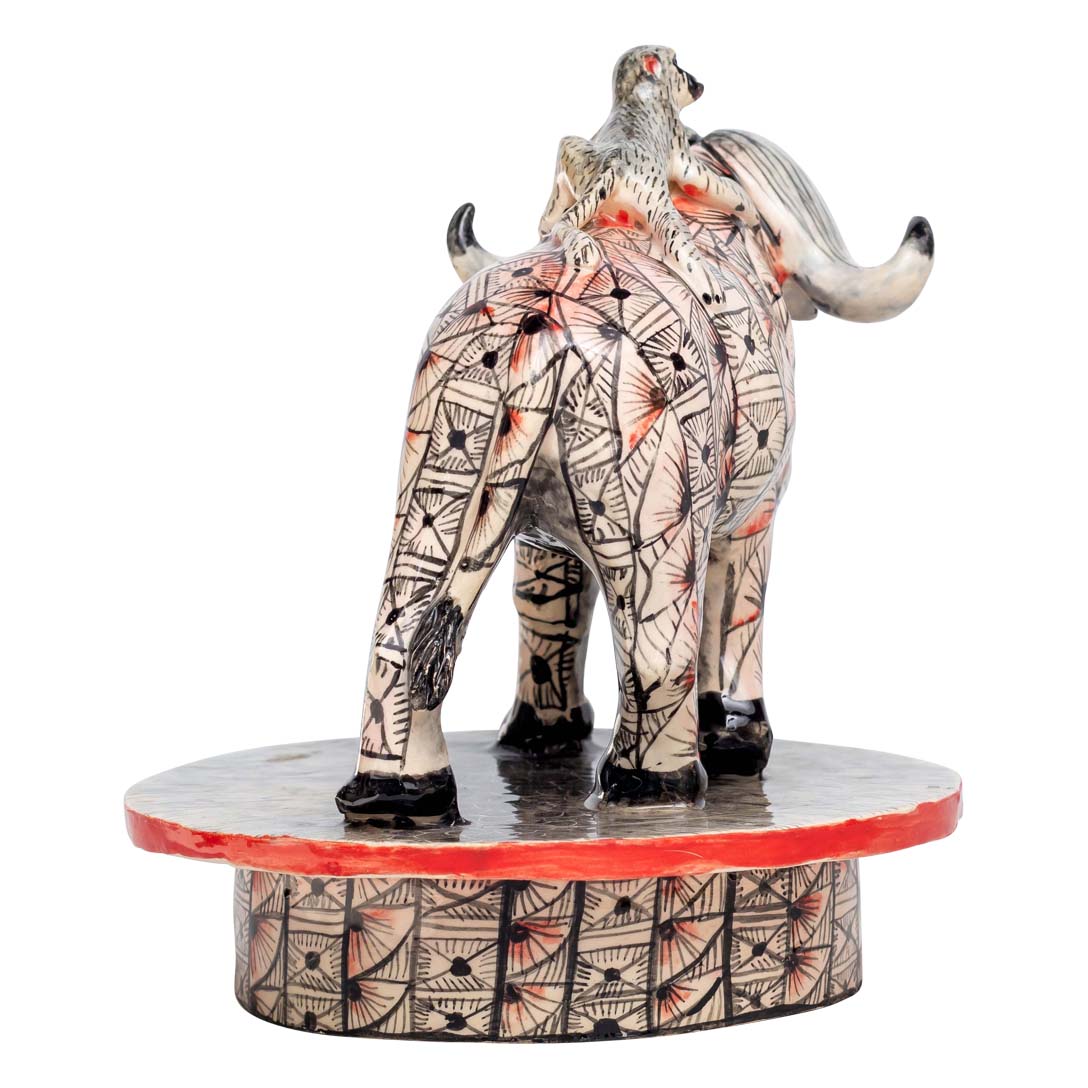 Monkey ridding a skin designed buffalo sculpture