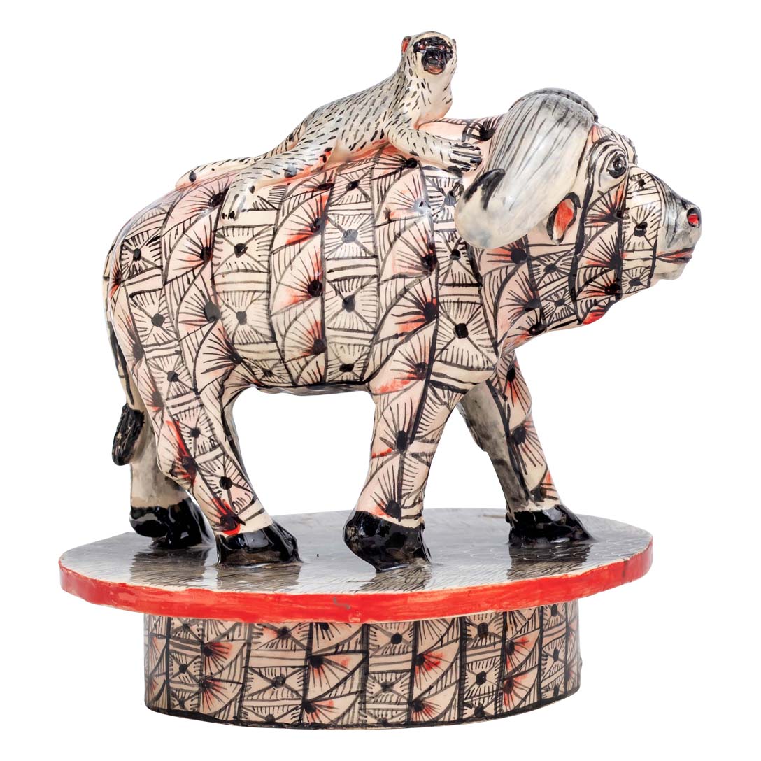 Monkey ridding a skin designed buffalo sculpture