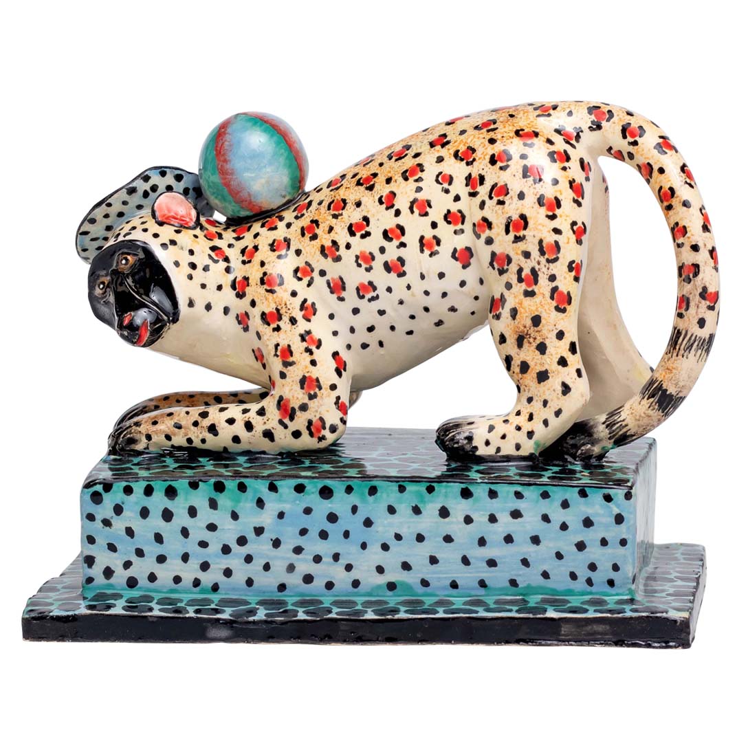 Leopard skin designed monkey playing ball sculpture