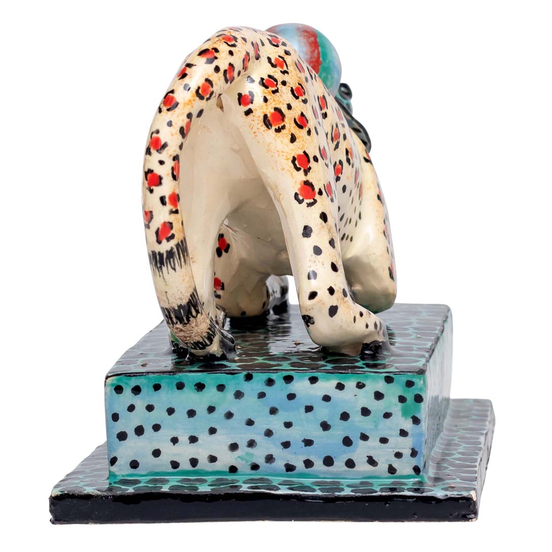 Leopard skin designed monkey playing ball sculpture