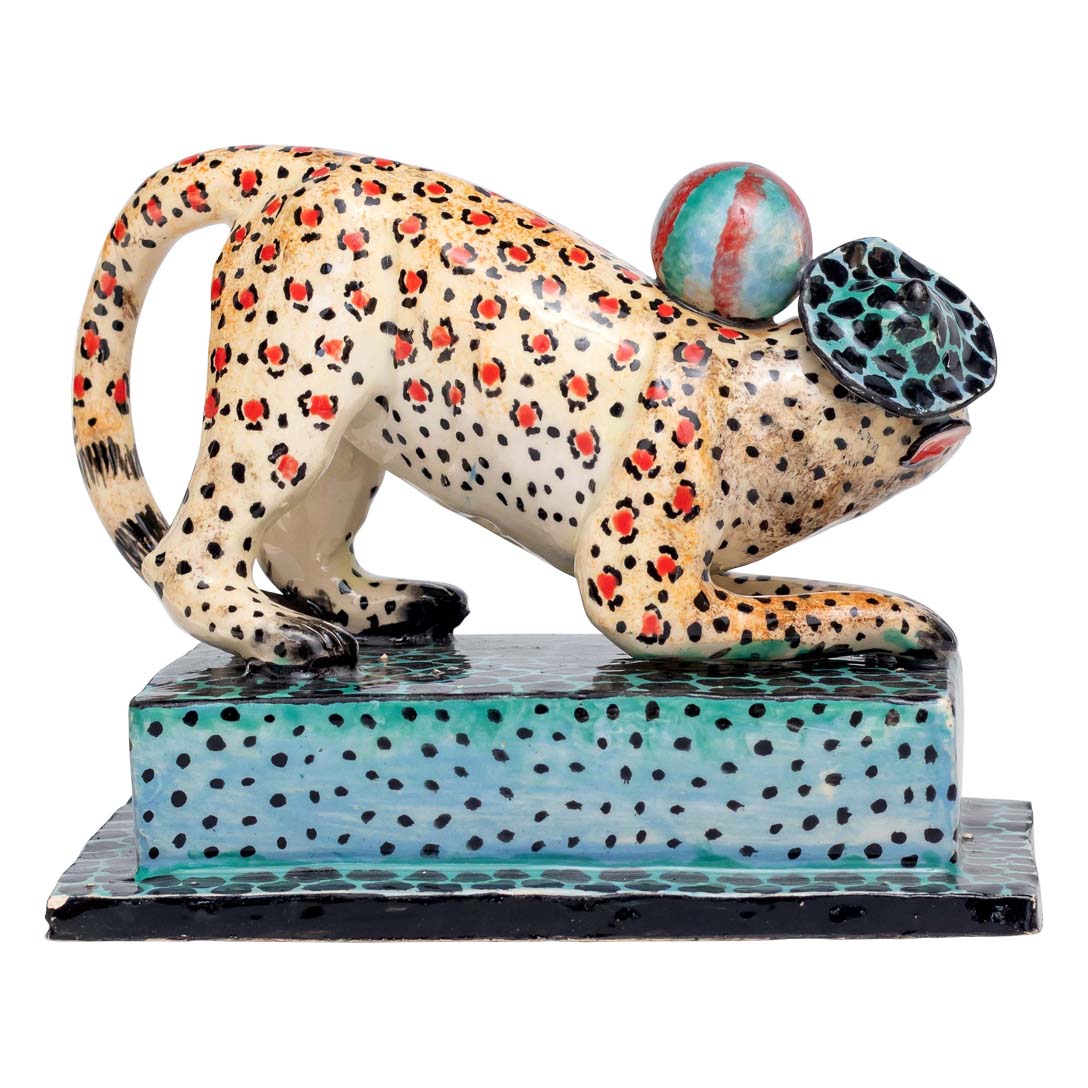 Leopard skin designed monkey playing ball sculpture