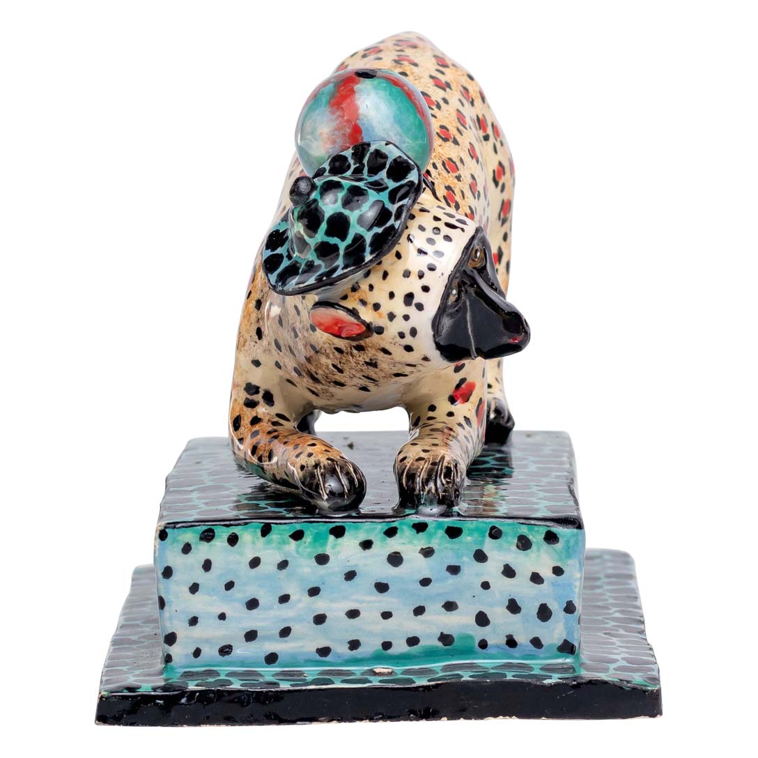 Leopard skin designed monkey playing ball sculpture